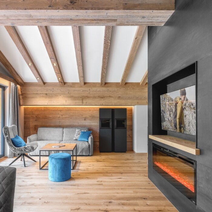 Chalet Arlberg mieten - Einzigartige Lage direkt im Skigebiet - 50 m zum Skilift - Chalets für 4 - 5 Personen - Wohnzimmer mit Kamin, TV und traumhaftem Blick in die Berge