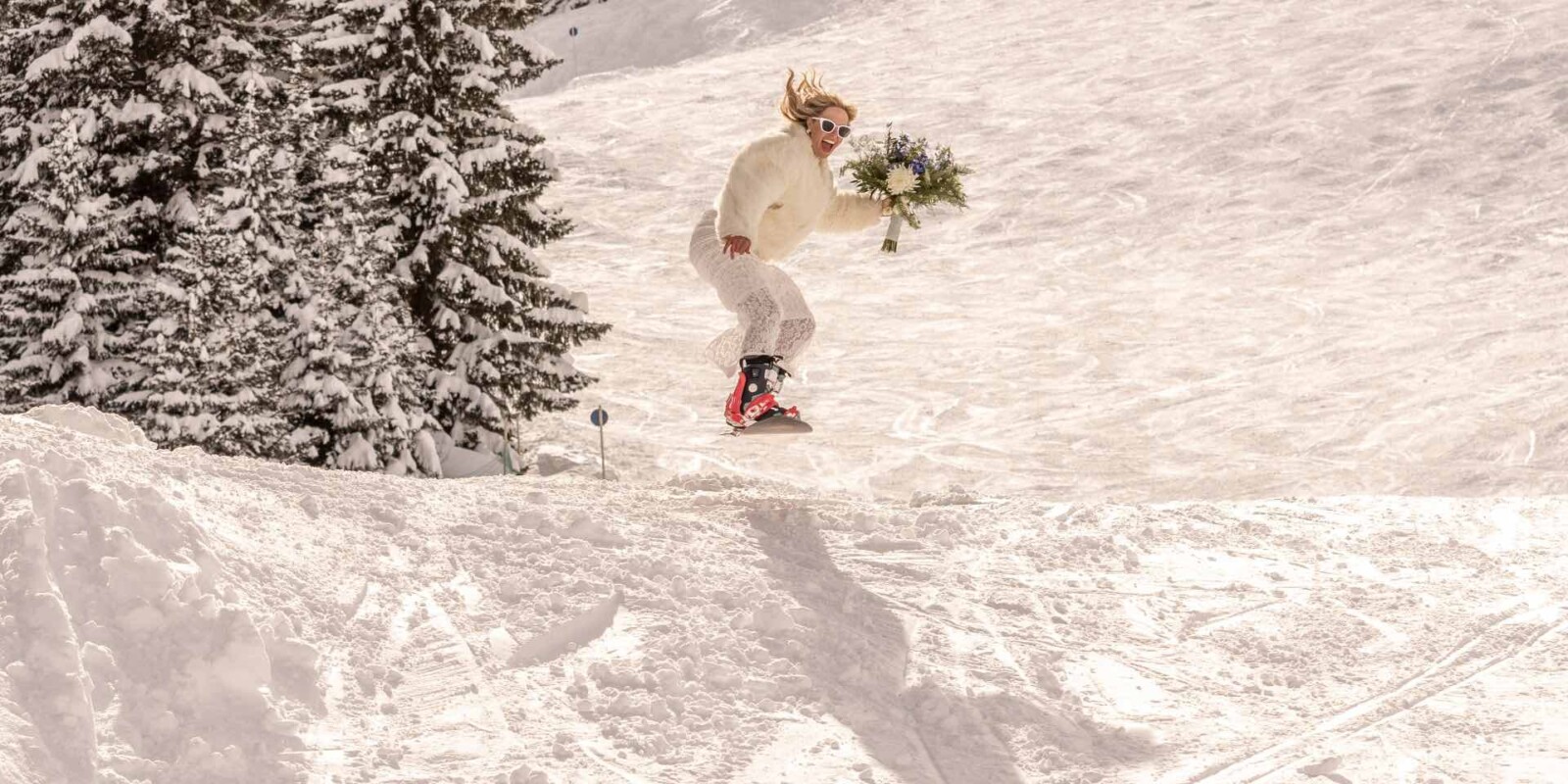 Die schönste Hochzeitslocation am Arlberg in Österreich – Braut auf Snowboard in den Bergen im Winter im Skigebiet Ski Arlberg